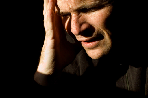 pain man clutching head.jpg